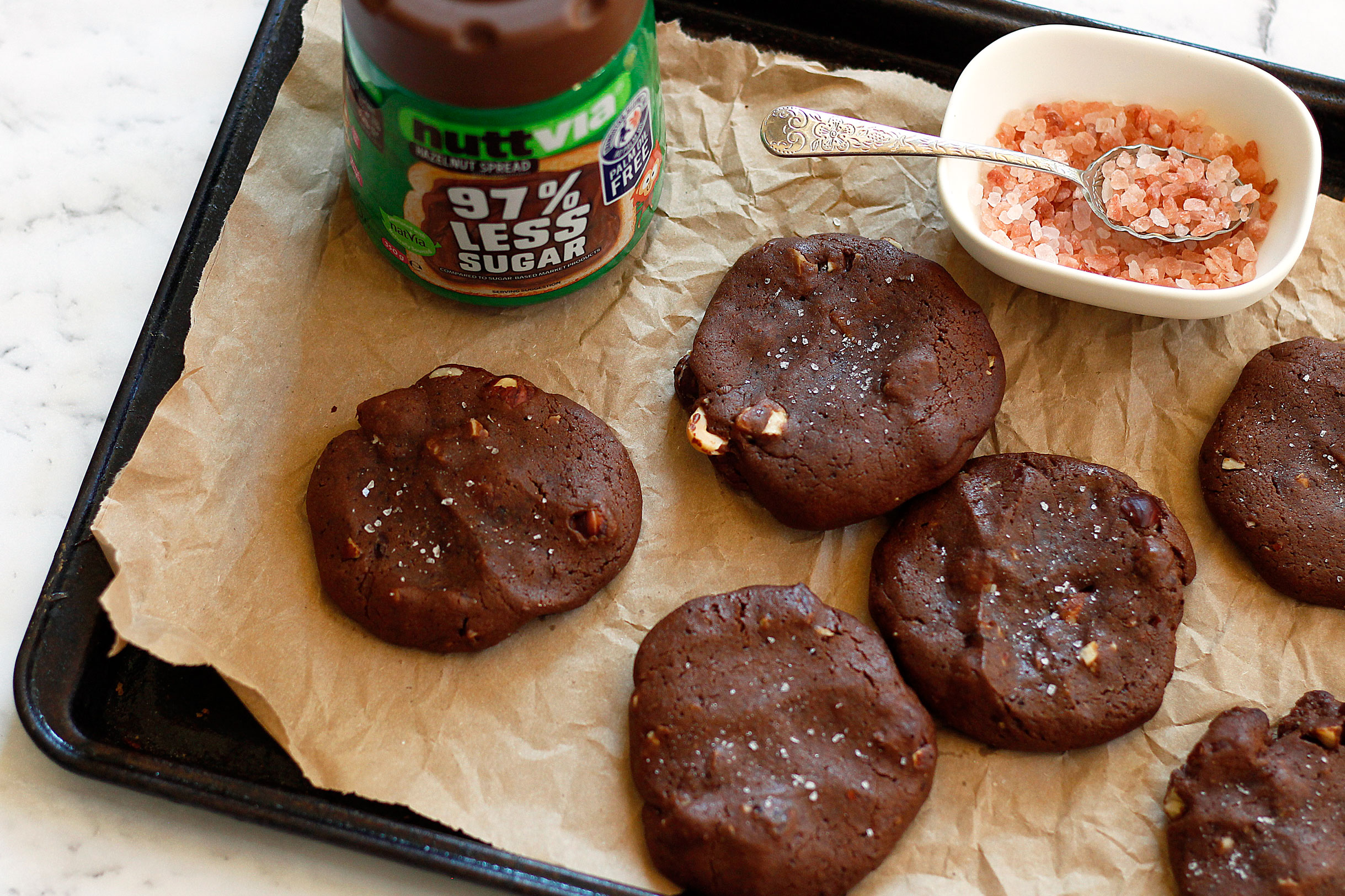 A jar of choc hazelnut spread and cookies on a tray