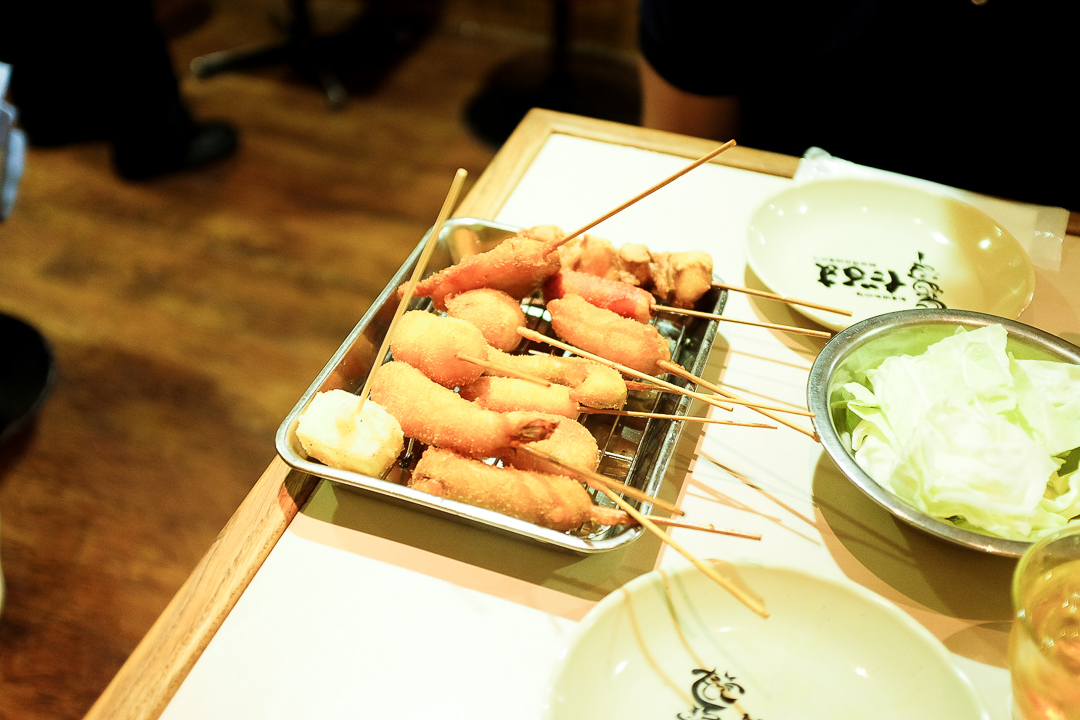 Kushikatsu in Osaka, Japan. Crunchy, breaded and deep fried meats vegetables and rice cakes on skewers