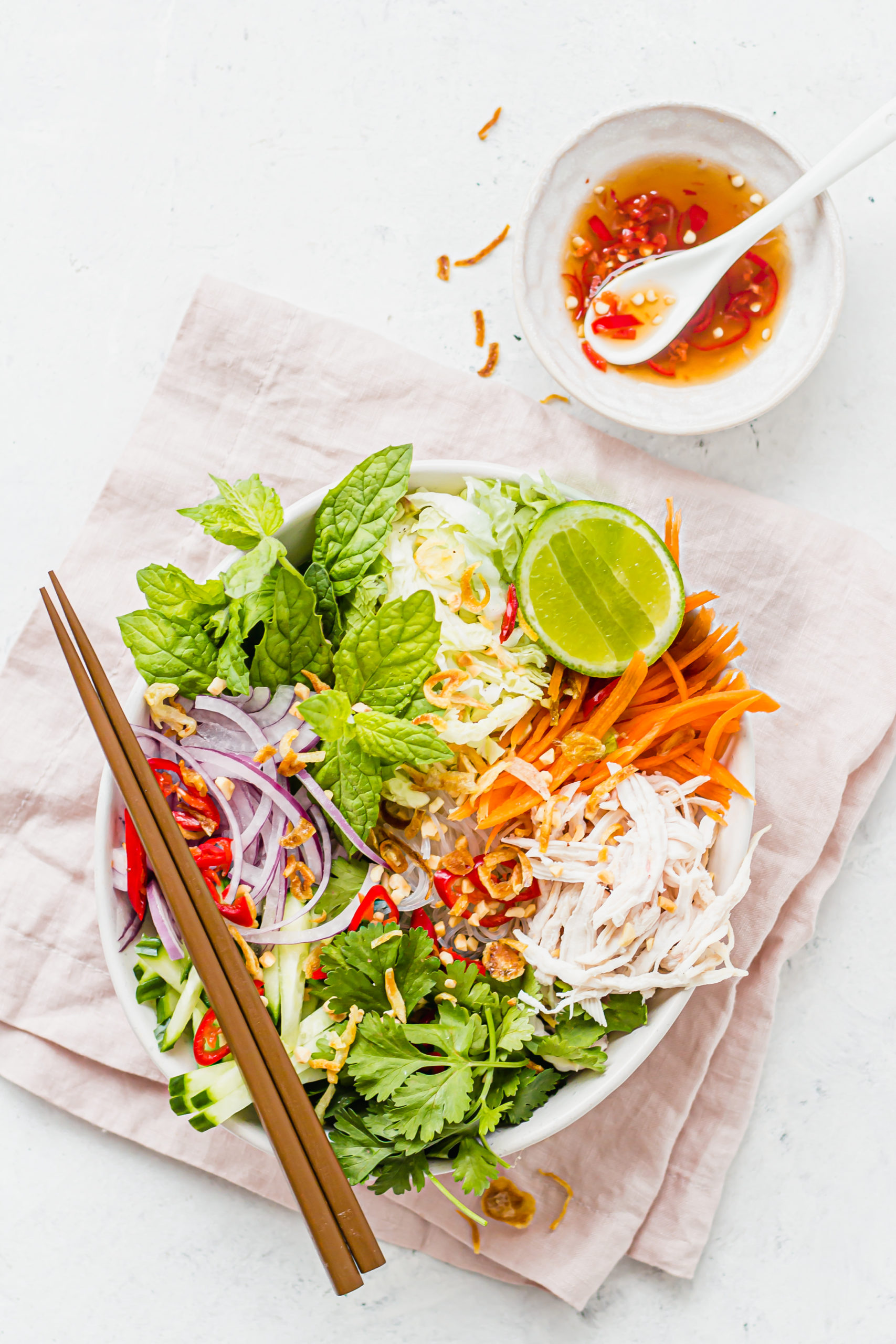 Top view of Vietnamese salad with a side of dressing