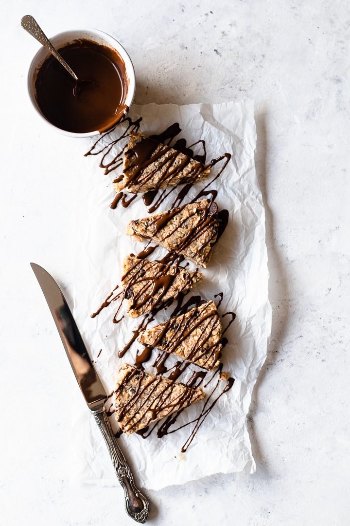 A line of chocolate caramel oat triangles drizzled with chocolate