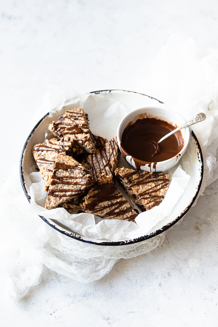 A bowl of caramel chocolate chip slice drizzled with dark chocolate