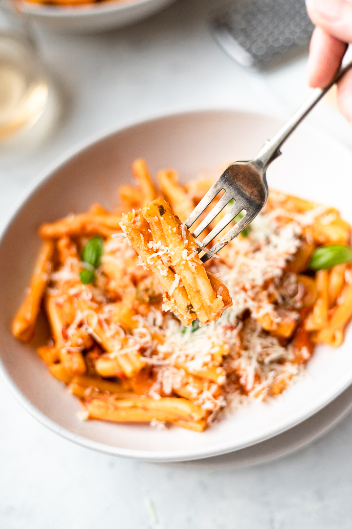 Close up of casarecce with vodka sauce on fork