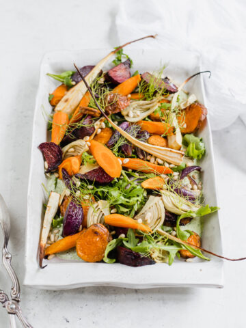 A platter of roasted root vegetable salad and herb yoghurt dressing