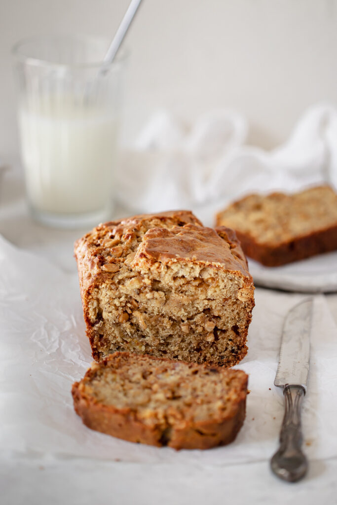 A loaf of caramilk banana bread with one slice cut away