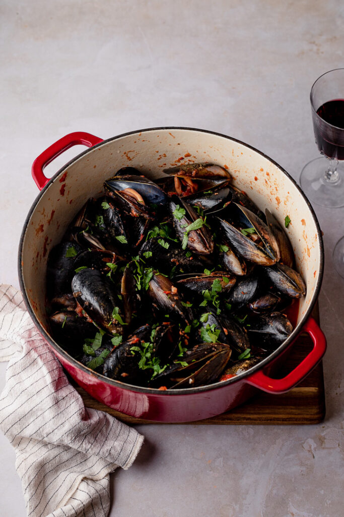 A pot of tomato garlic mussels