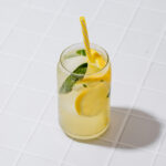 A tall glass filled with salted sage lemonade