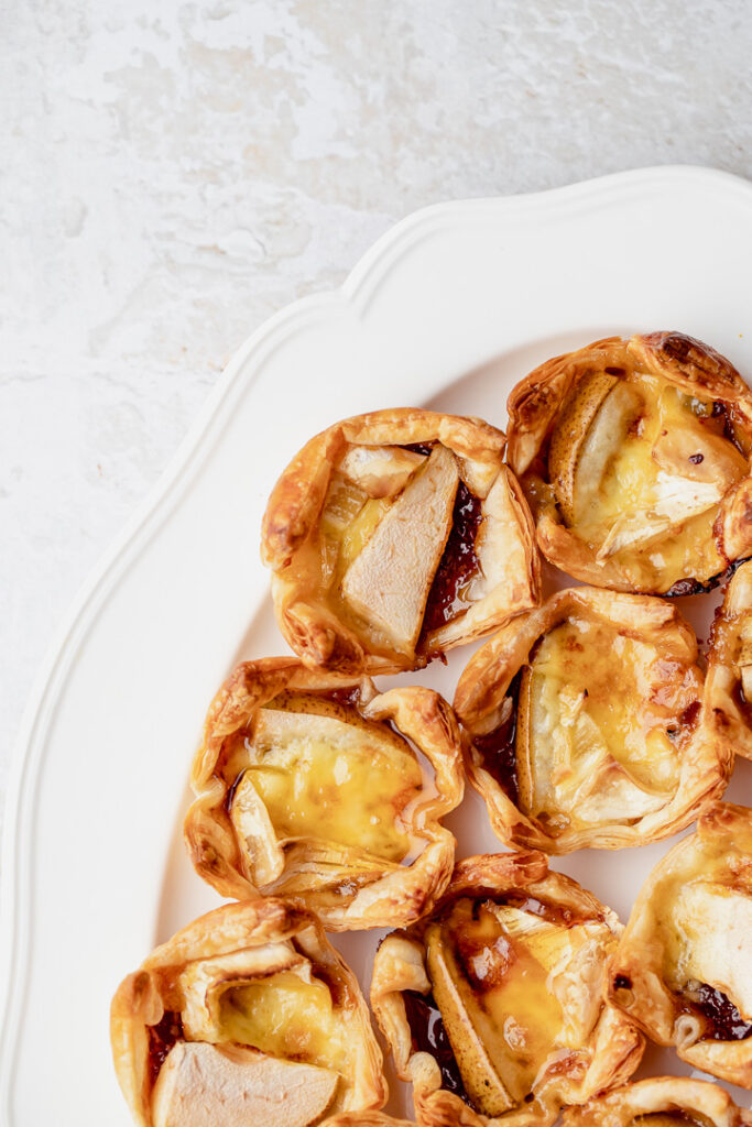 A plate of pear, caramelised onion and brie bites